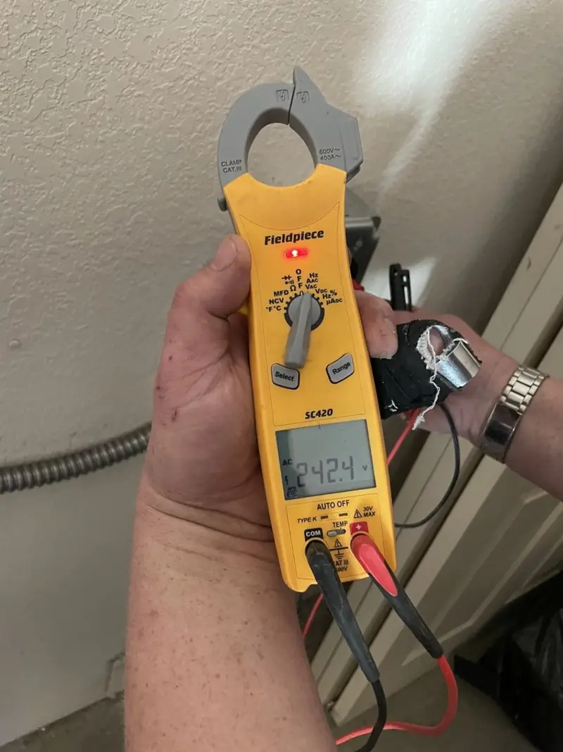 Voltage testing with clamp meter during Electrical Installation Services in Norman